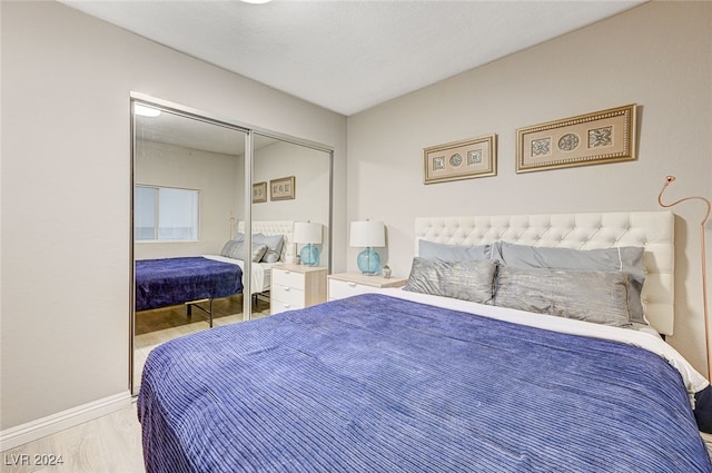 bedroom featuring light wood-type flooring and a closet