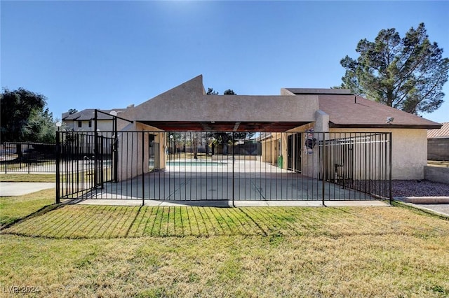 exterior space with a lawn, a patio, and a community pool