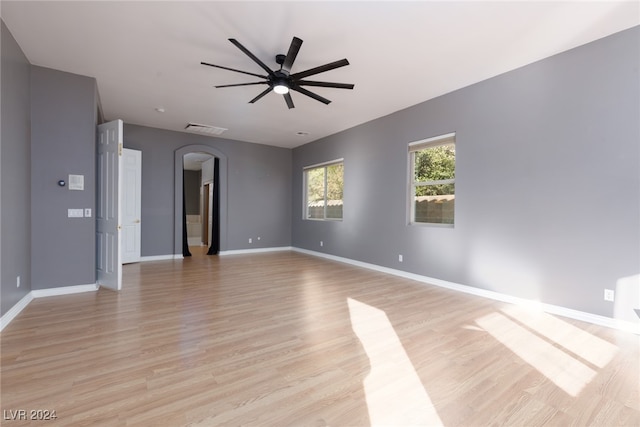 spare room with ceiling fan and light wood-type flooring