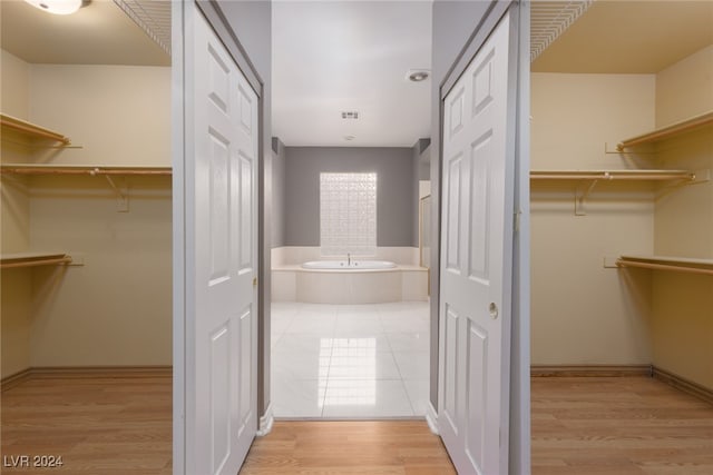 spacious closet featuring light hardwood / wood-style floors