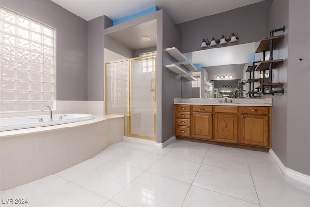 bathroom with tile patterned floors, vanity, a wealth of natural light, and plus walk in shower