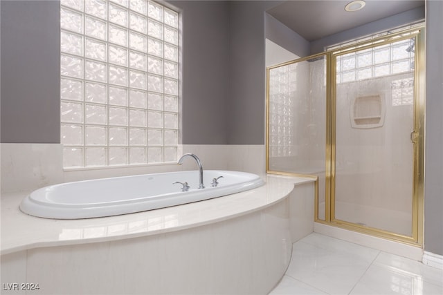 bathroom featuring separate shower and tub