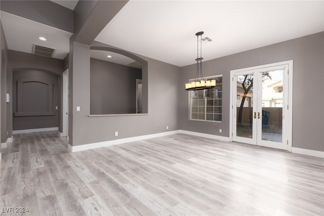 unfurnished dining area featuring light hardwood / wood-style flooring and french doors