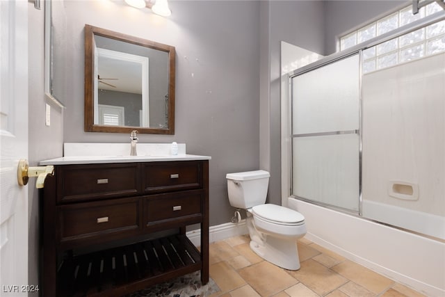 full bathroom with shower / bath combination with glass door, ceiling fan, vanity, and toilet