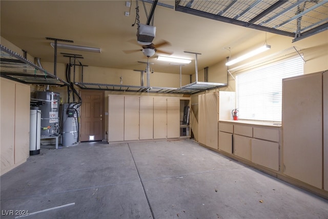 garage with secured water heater, a garage door opener, and ceiling fan