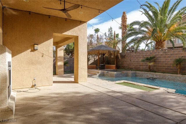 view of swimming pool with a gazebo, a hot tub, and a patio area