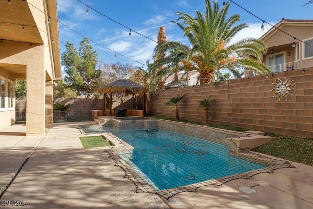 view of swimming pool with a gazebo and a patio area