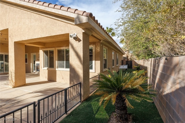 view of side of home featuring a patio area