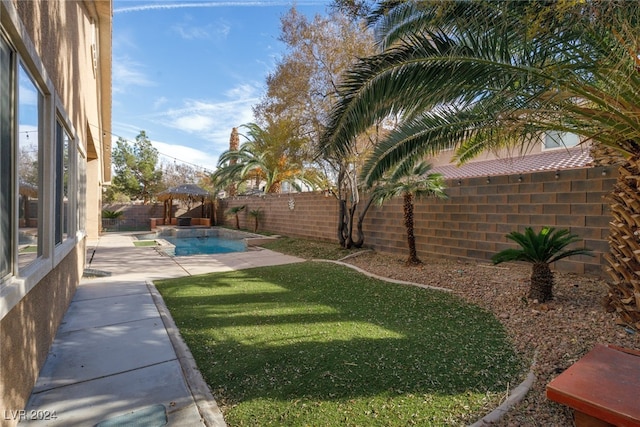 view of yard with a fenced in pool, a gazebo, and a patio