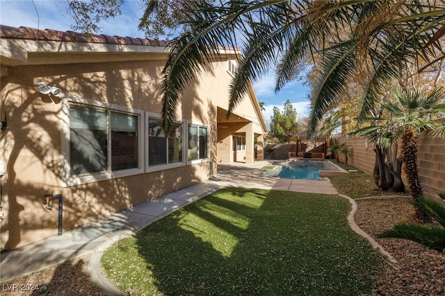 view of yard featuring a fenced in pool and a patio