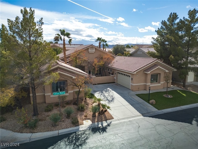 view of front facade with a garage and a front lawn