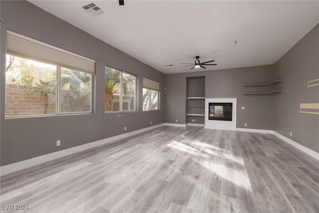 unfurnished living room with ceiling fan and light hardwood / wood-style floors