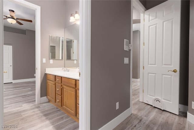 bathroom with ceiling fan, wood-type flooring, and vanity