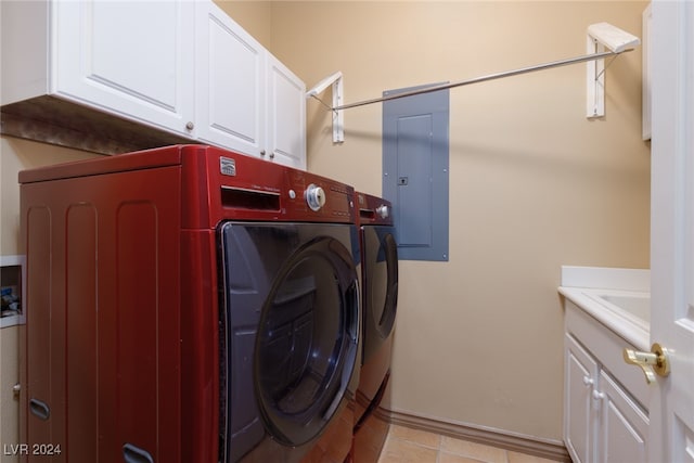 laundry room featuring cabinets, electric panel, sink, washing machine and dryer, and light tile patterned floors