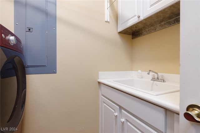 washroom featuring electric panel, sink, and cabinets