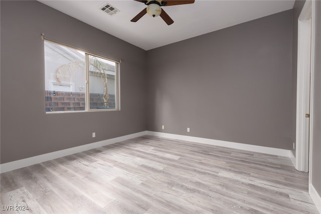 empty room with ceiling fan and light wood-type flooring