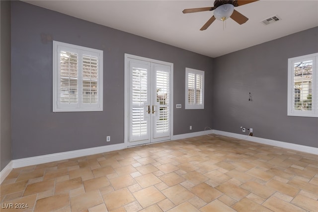 unfurnished room featuring ceiling fan and french doors