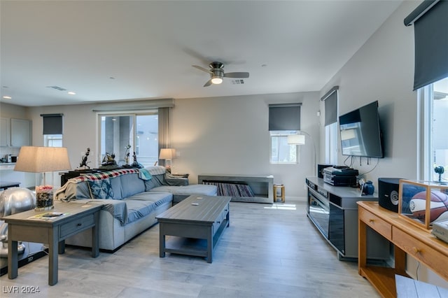 living room featuring ceiling fan and light hardwood / wood-style floors