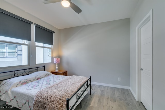 bedroom with ceiling fan and light hardwood / wood-style flooring