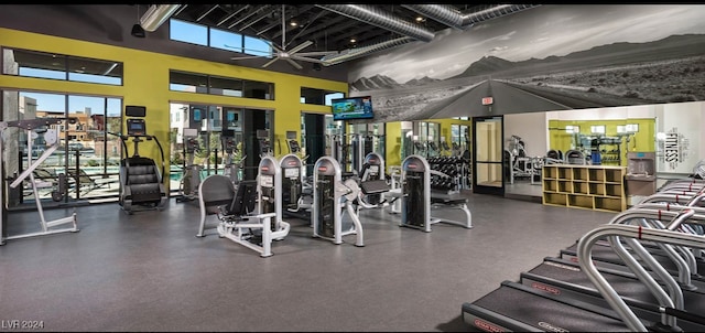 workout area featuring a towering ceiling and ceiling fan