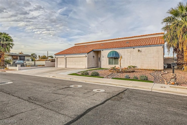 mediterranean / spanish-style home featuring a garage