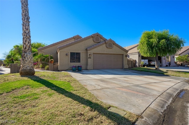 view of front of property with a front yard and a garage