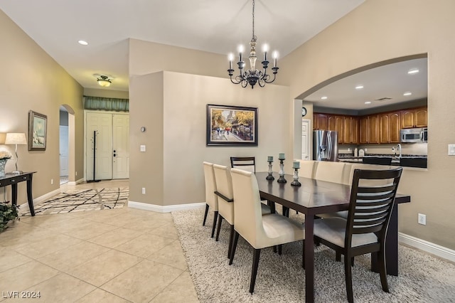 dining space with a notable chandelier and light tile patterned flooring