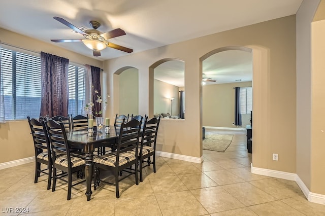 tiled dining space with ceiling fan