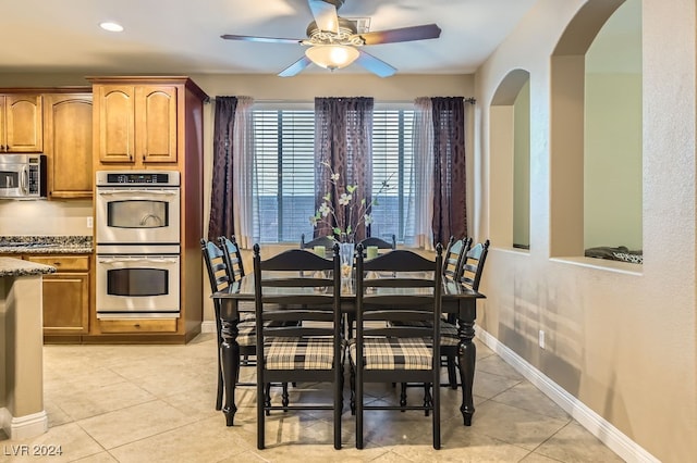 tiled dining room with ceiling fan