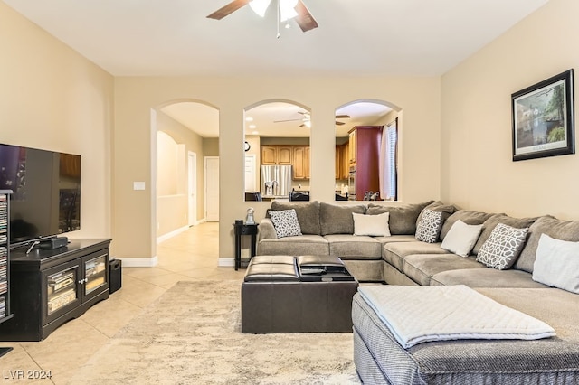 tiled living room with ceiling fan