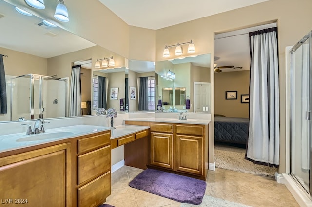 bathroom with ceiling fan, a shower with shower door, and vanity