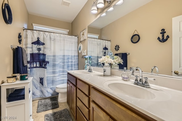 bathroom featuring tile patterned flooring, vanity, and toilet