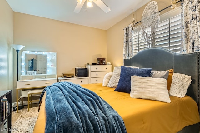 bedroom with ceiling fan and lofted ceiling