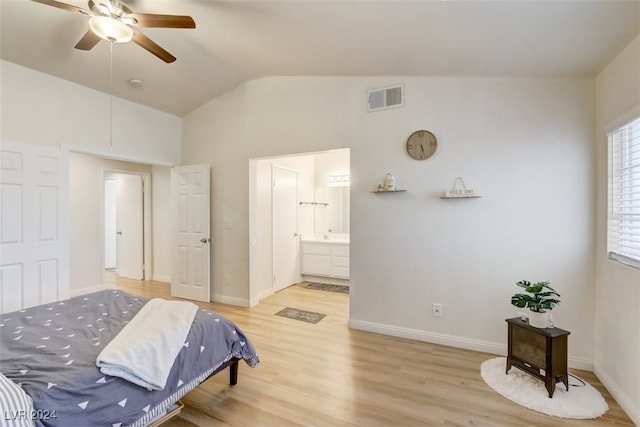 bedroom featuring connected bathroom, ceiling fan, light hardwood / wood-style floors, and vaulted ceiling