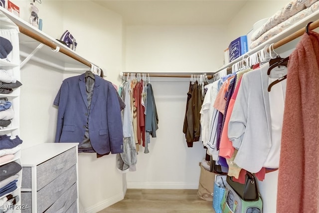 walk in closet featuring light hardwood / wood-style flooring