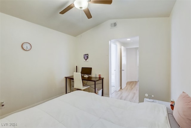 bedroom with ceiling fan, light hardwood / wood-style flooring, and vaulted ceiling