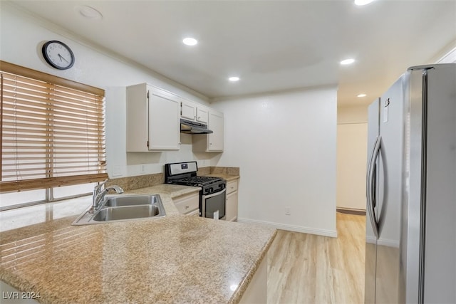 kitchen featuring sink, kitchen peninsula, light hardwood / wood-style floors, white cabinets, and appliances with stainless steel finishes