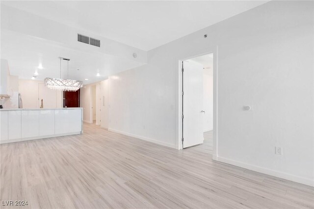 4575 Dean Martin Dr Unit 2211, Las Vegas, NV 89103 - unfurnished living room with light wood-style flooring and baseboards