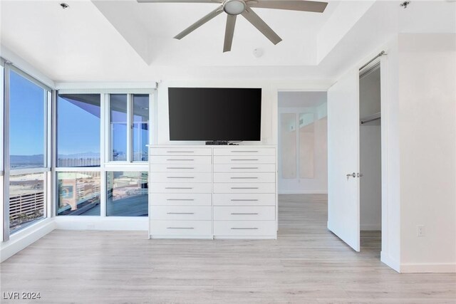 4575 Dean Martin Dr Unit 2211, Las Vegas, NV 89103 - unfurnished bedroom with light wood-style floors, baseboards, and ceiling fan