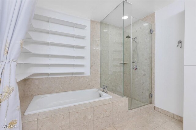 4575 Dean Martin Dr Unit 2211, Las Vegas, NV 89103 - full bath featuring a bath, a shower stall, and tile patterned flooring