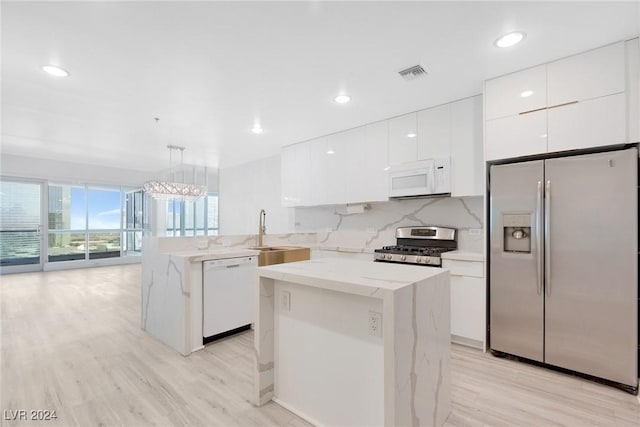 4575 Dean Martin Dr Unit 2211, Las Vegas, NV 89103 - kitchen with appliances with stainless steel finishes, modern cabinets, a sink, light wood-type flooring, and recessed lighting
