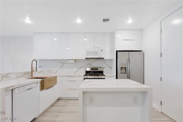 4575 Dean Martin Dr Unit 2211, Las Vegas, NV 89103 - kitchen featuring appliances with stainless steel finishes, modern cabinets, a sink, white cabinetry, and recessed lighting