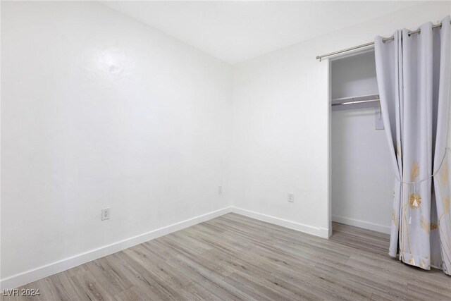 4575 Dean Martin Dr Unit 2211, Las Vegas, NV 89103 - unfurnished bedroom featuring wood finished floors, baseboards, and a closet