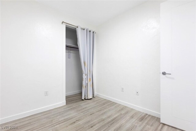 4575 Dean Martin Dr Unit 2211, Las Vegas, NV 89103 - unfurnished bedroom with light wood-style flooring, baseboards, and a closet