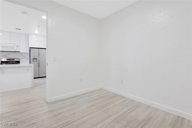 4575 Dean Martin Dr Unit 2211, Las Vegas, NV 89103 - unfurnished room featuring light wood finished floors, baseboards, and recessed lighting