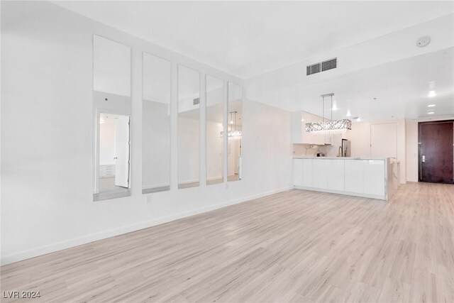 4575 Dean Martin Dr Unit 2211, Las Vegas, NV 89103 - unfurnished living room with light wood-style floors and baseboards