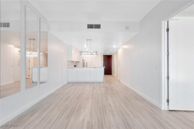 4575 Dean Martin Dr Unit 2211, Las Vegas, NV 89103 - unfurnished living room with light wood-style floors and baseboards