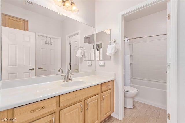 full bathroom with shower / bath combo, toilet, and vanity