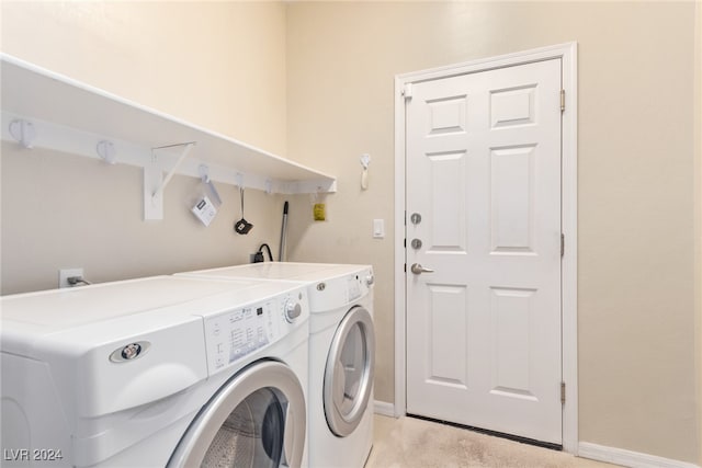 laundry room with light carpet and washer and clothes dryer