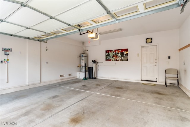 garage featuring water heater and a garage door opener